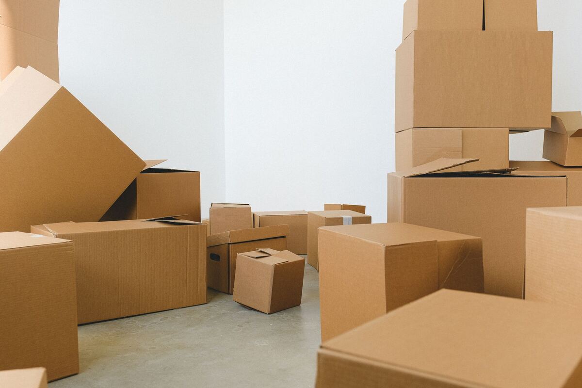 Open cardboard boxes in a bright empty room
