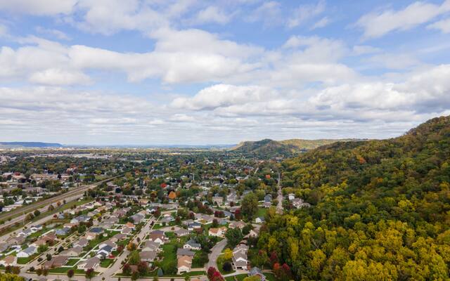 Aerial view of suburban streets running out to wooded hills