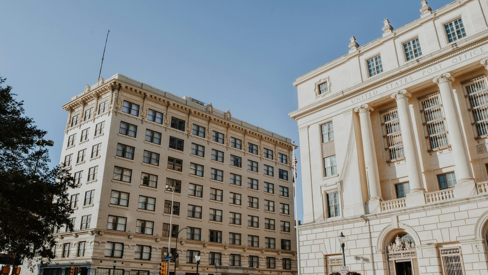 Historic downtown San Antonio office buildings beside the United States Post Office under a clear sky