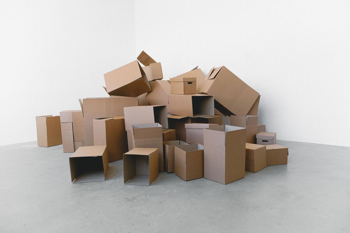 Cardboard moving boxes stacked in an empty room