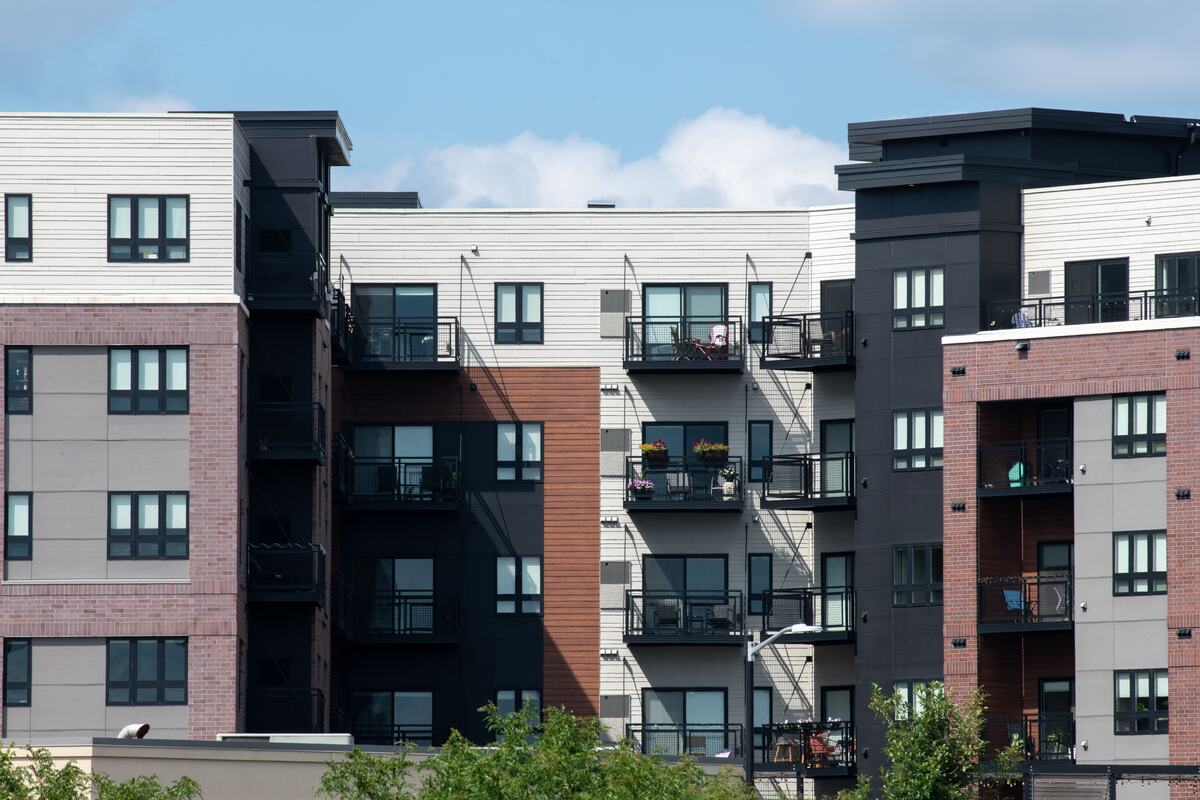 Newly built apartment buildings in mixed brick and panel against a clear sky