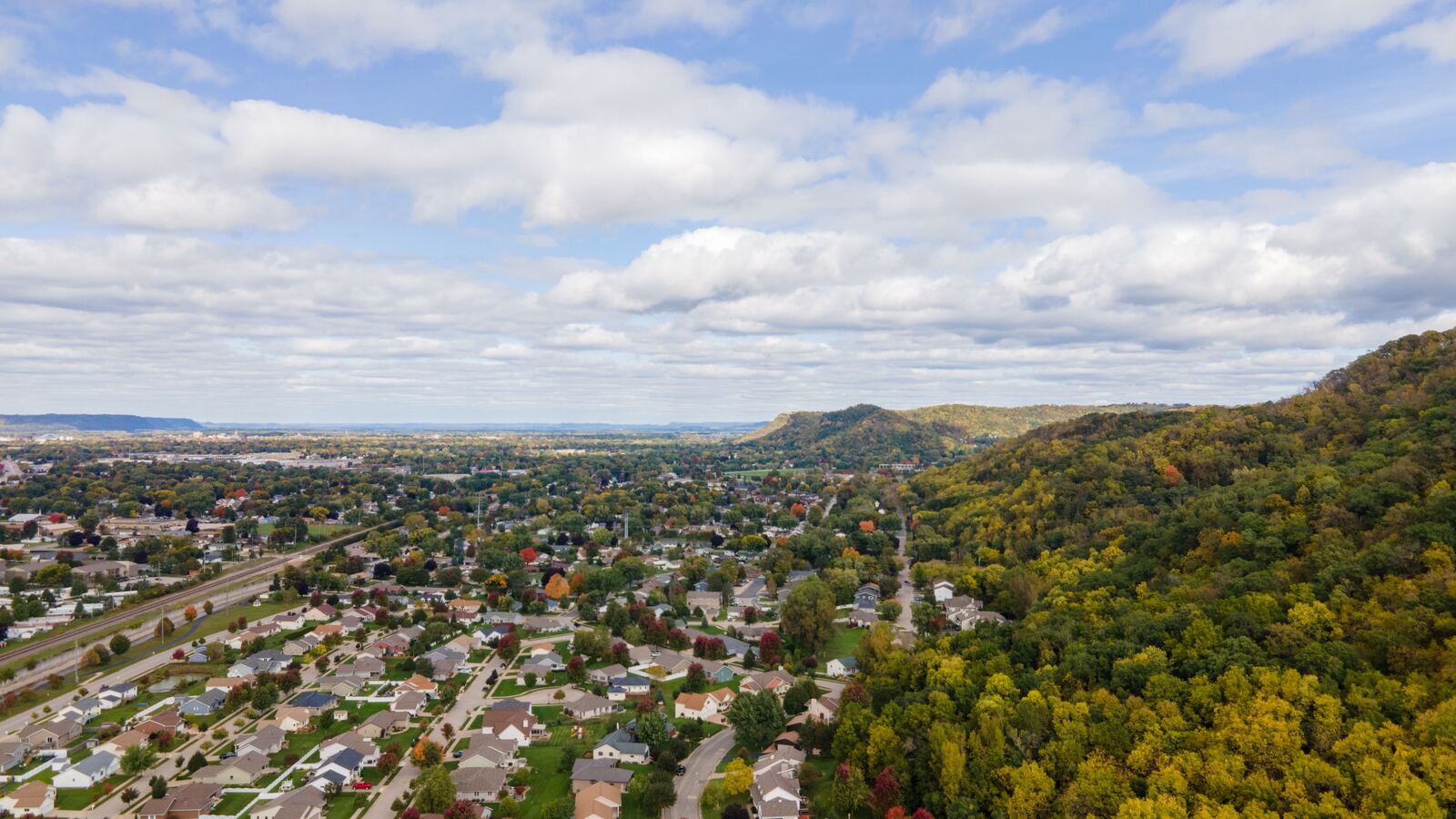 Aerial view of suburban streets running out to wooded hills